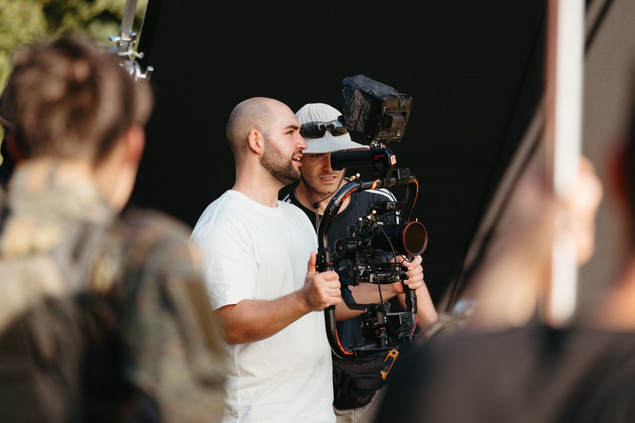 The Visionary Berlin director and cinematographer collaborating on set, using a stabilized camera rig to capture dynamic, high-action sequences for the Saab L20C film.
