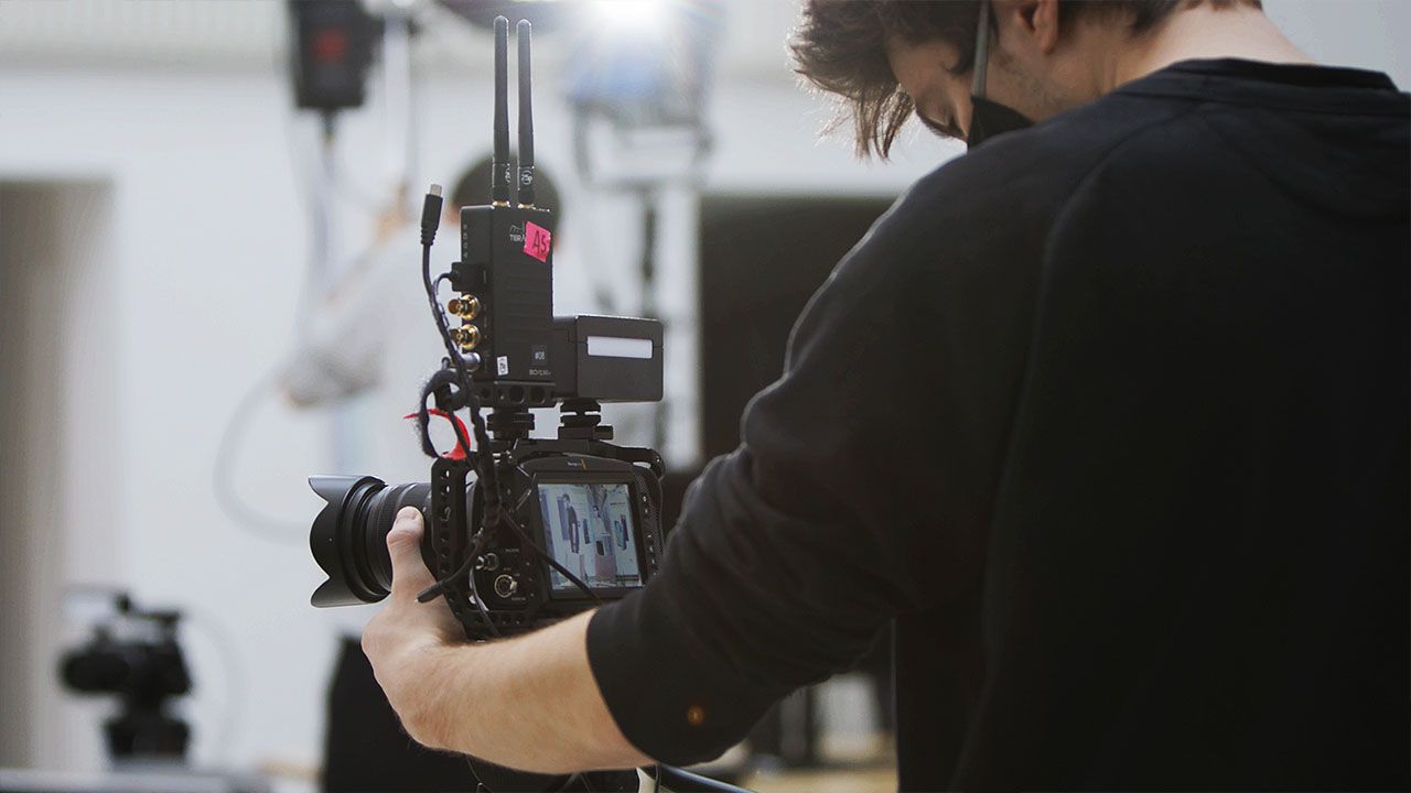 A close-up of a Visionary Berlin cinematographer operating a professional camera rig, capturing high-quality footage for the Huawei Rebels livestream.