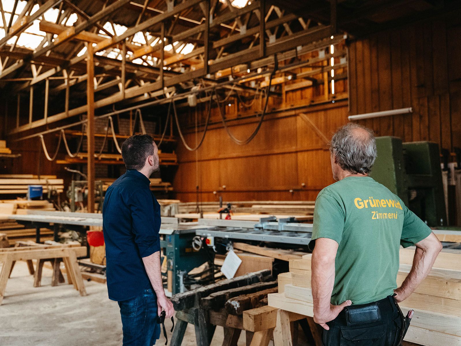 Fotodokumentation von Visionary Berlin zur Sommertour von Konstantin Kuhle. Der Bundestagsabgeordnete im Dialog mit einem lokalen Handwerker vor einem traditionellen Fachwerkhaus.