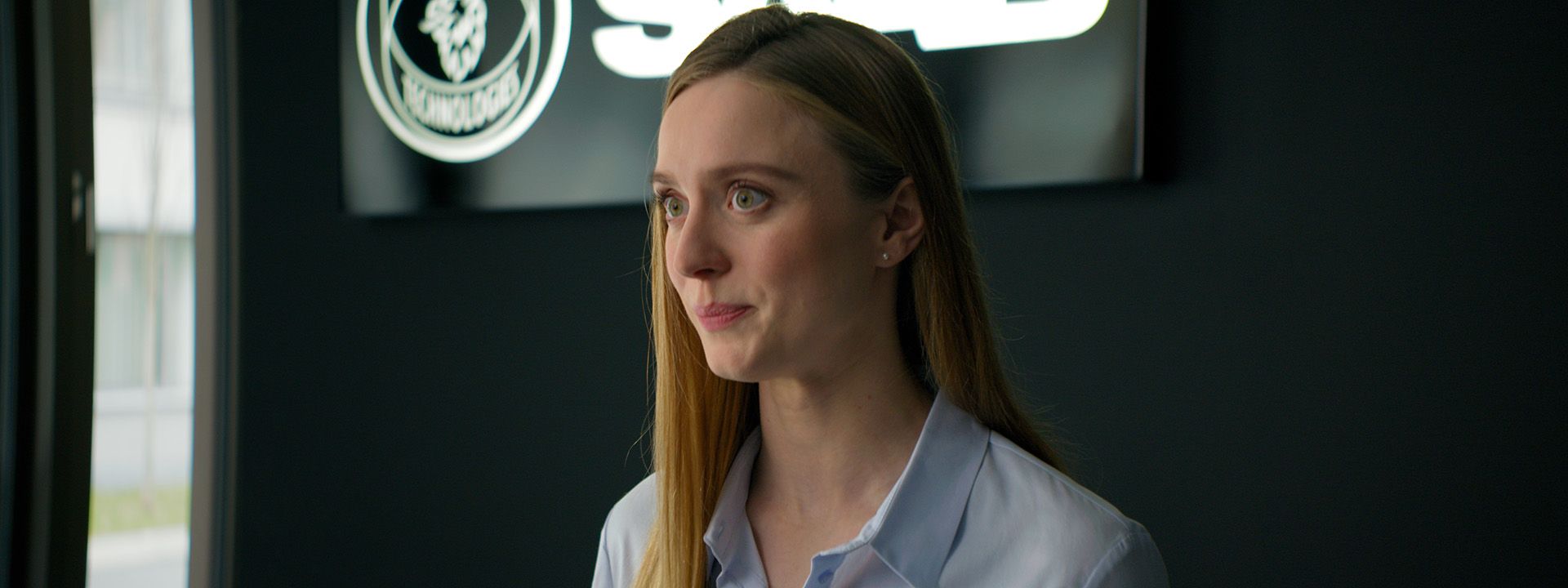 A cinematic close-up of the actress portraying a modern Saab employee, delivering a welcoming and confident look in the final brand film produced by Visionary Berlin.