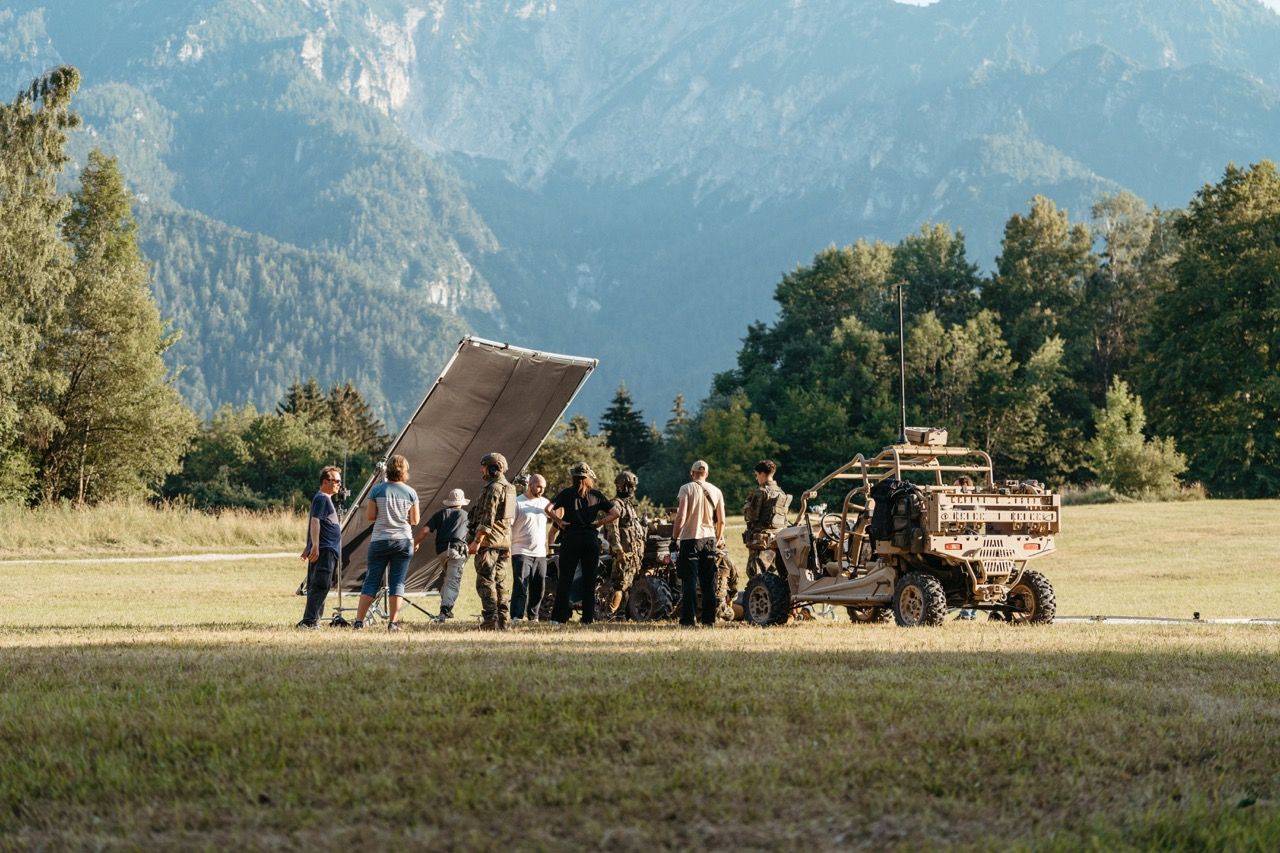 The full Visionary Berlin production team, actors, and equipment on location for the Saab L20C film, set against a vast mountain landscape to create an authentic and realistic scenario.