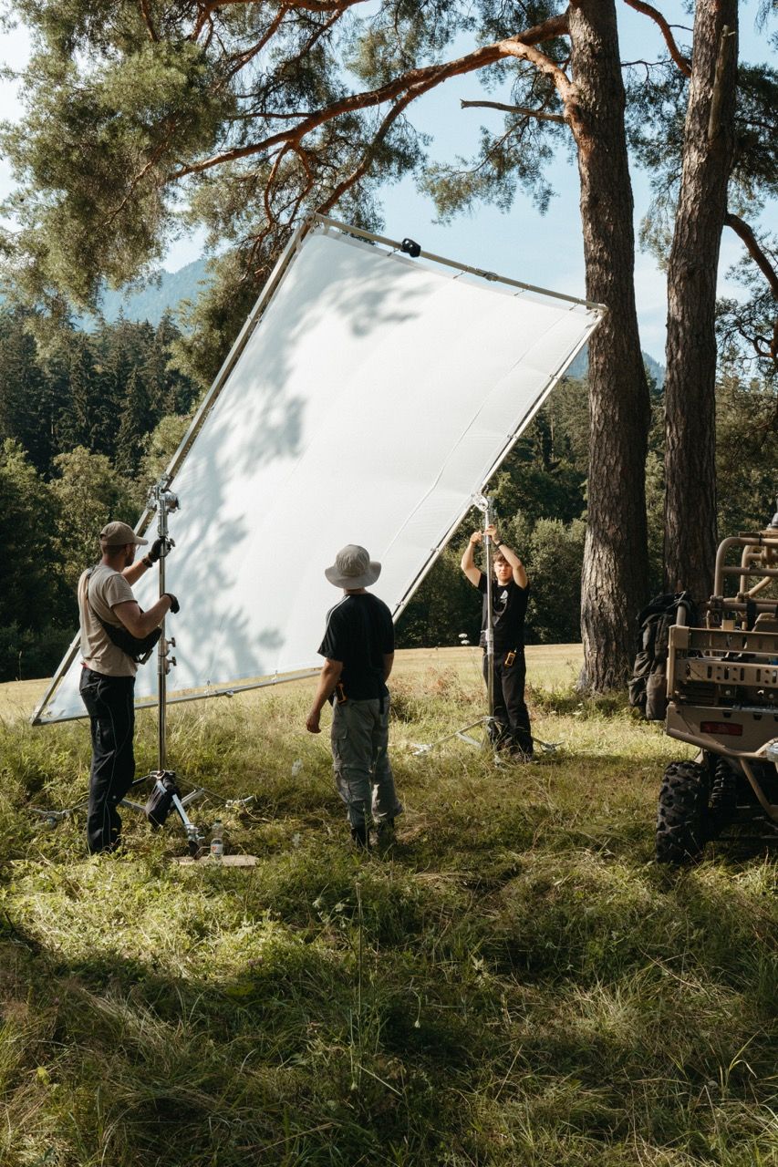 The Visionary Berlin crew sets up a large light diffusion frame in a remote outdoor location to ensure cinematic lighting quality for the Saab Sirius Compact L20C launch film.