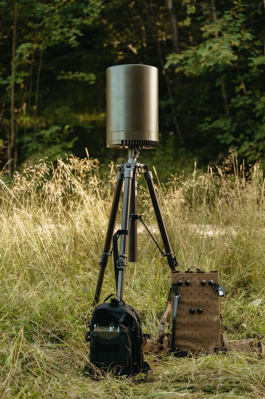 A professional product photo of the Saab Sirius Compact L20C sensor, showcased in a field environment to highlight its compact, robust design and suitability for tactical deployment.