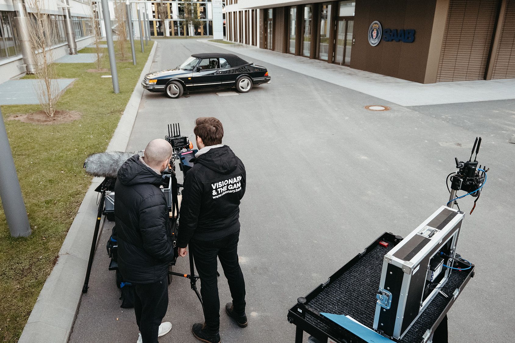 The 'Visionary & The Gang' production crew sets up a shot outside the Saab Technologies building, capturing a key scene for the brand film.