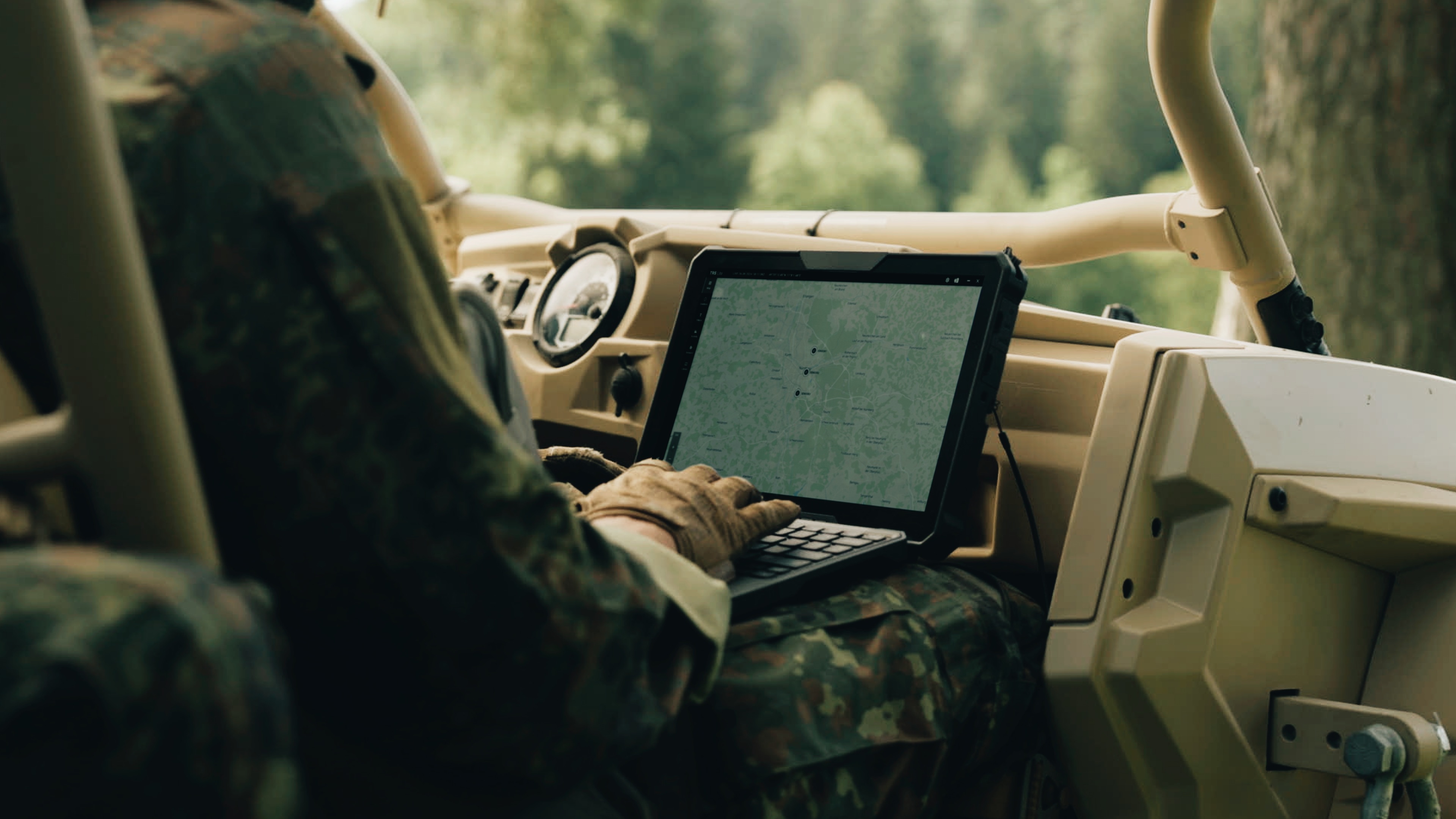 A shot from the Saab L20C film demonstrating the integration of technology, as a soldier uses a rugged tactical tablet for mission data inside an all-terrain vehicle.