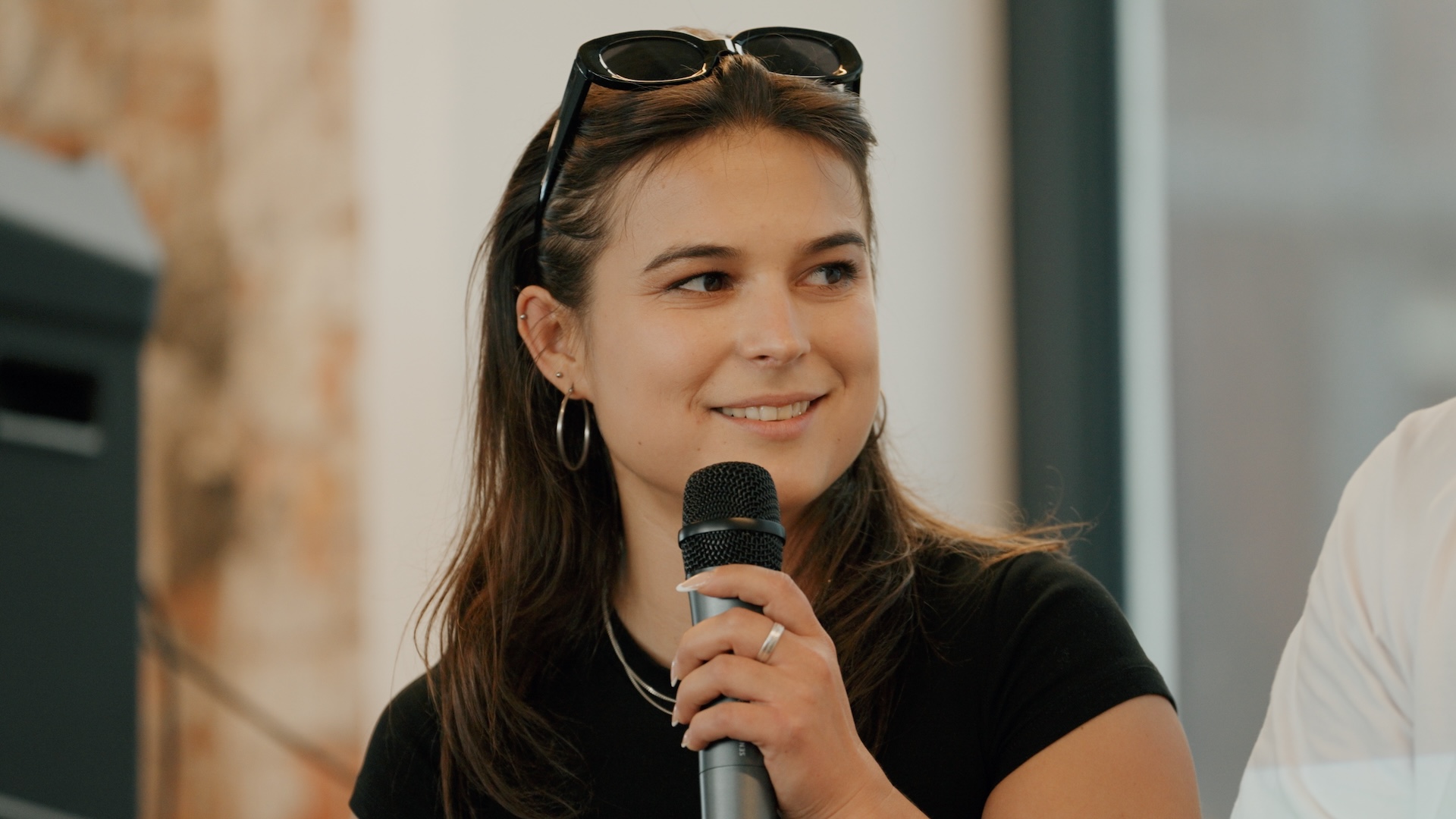 An engaging close-up of a speaker sharing insights during the Berlin Blockchain Week at w3.hub. A still from the event film produced by Visionary Berlin.