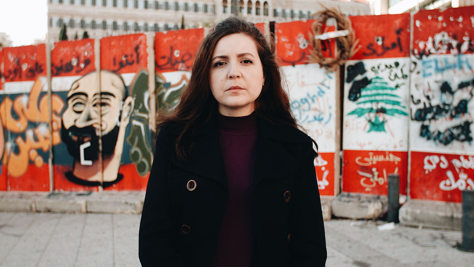 Luna Safwan standing in Beirut in front of a wall